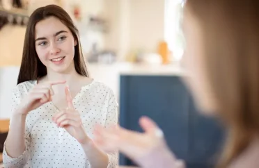 0_Two-Teenage-Girls-Having-Conversation-Using-Sign-Language